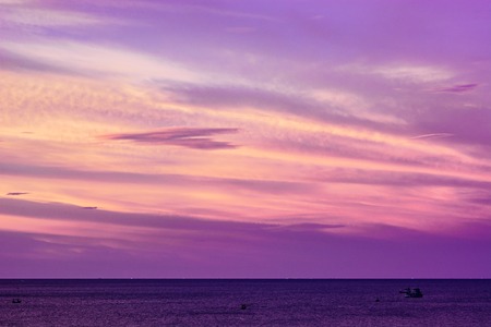 Summer beach with violet sky at the sunset. Seascape with purple sky and cloudsの写真素材