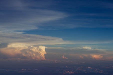 Aerial view scenic sunset sky above clouds with dramatic light. View from airplaneの写真素材