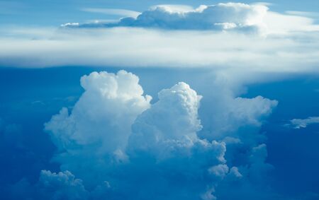 Aerial view scenic sunset sky above clouds with dramatic light. View from airplane