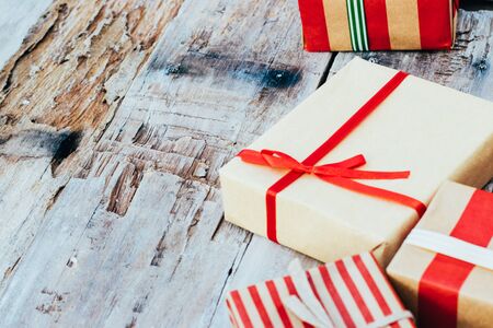 Christmas background with christmas gift boxes on the wooden board. New year walpaper.