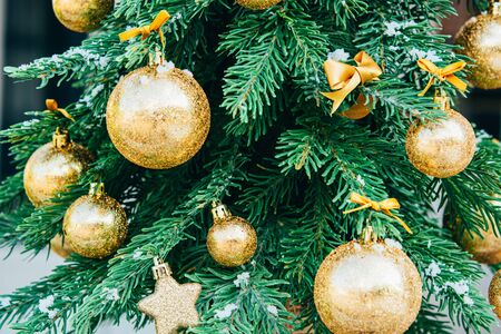Merry christmas background. Green fir tree with golden balls and ribbon.の写真素材