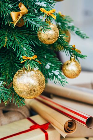 Merry christmas background. Green fir tree with golden balls and ribbon.の写真素材