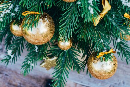 Merry christmas background. Green fir tree with golden balls, gift boxes and ribbon.の写真素材