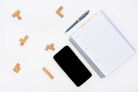 notebook with pencil and mobile
