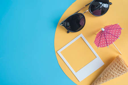 Concept summer with glasses, photos, umbrella and cornの写真素材