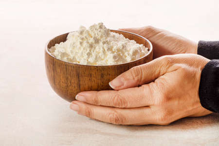 Corn flour in wooden bowl close upの写真素材