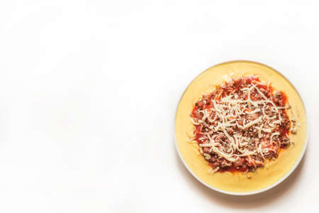 Polenta with tomato, cheese and minceの写真素材