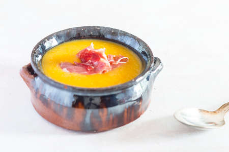 Cream of pumpkin with ham and eggの写真素材