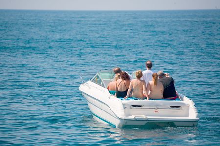 A group of seven people  on the yachtの写真素材