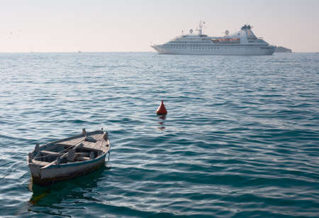 Big Cruise Ship and small boat on the seaの写真素材