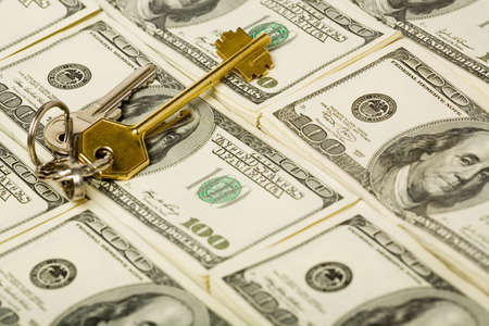 Stacks of $100 dollar bills with key の写真素材
