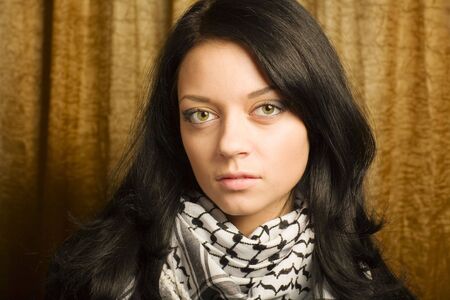 Young pretty woman in arafatka. Portrait at homeの写真素材