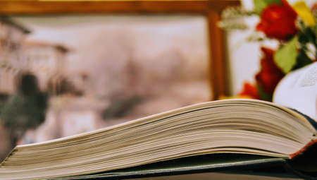 Open book on the group of encyclopedia with blurred background.の写真素材
