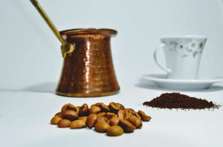 Turkish Coffee content with isolated photo. Roasted and fine milled beans. Turkish coffee pot and dish. Isolated white background.の写真素材