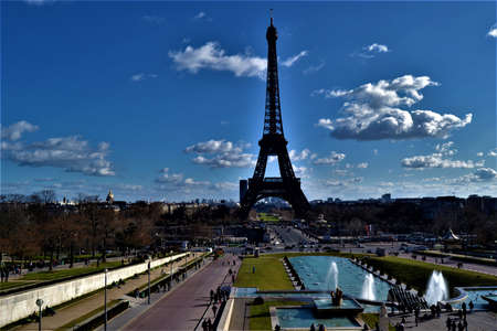 City sign of the Paris, France: Eiffel. Statue of Eiffel made of full metal and steel, Paris, France during light cloudy day and blue sky.のeditorial素材