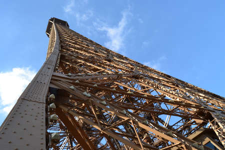 Top of the Eiffel Tower with blue sky. The great and the most well known building of Paris, France....
