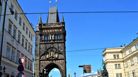 Street signs and powder gate in Prague. Blue sky background and street signs. Power gate and Tower in Prague, Czech Republic.の写真素材