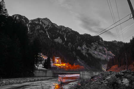 Night photo, local colorful and black and white photo, street lamp and its reflection on iced river...
