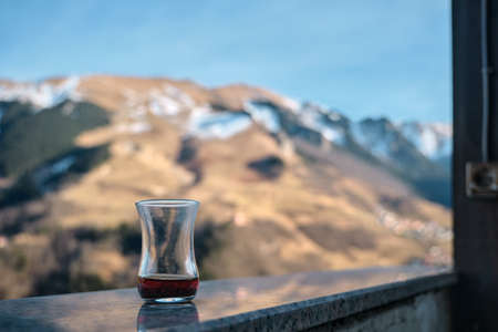 slim waisted tea glass. finished traditional turkish tea and reflection on marbles stone in macka, hamsikoy trabzon.の写真素材