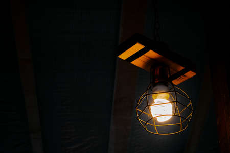 Vintage lamp, retro style lamp and light reflection on top of wood and isolated background.の写真素材