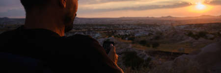 A man looking to sun at sunset watching valley in cappadocia.の写真素材