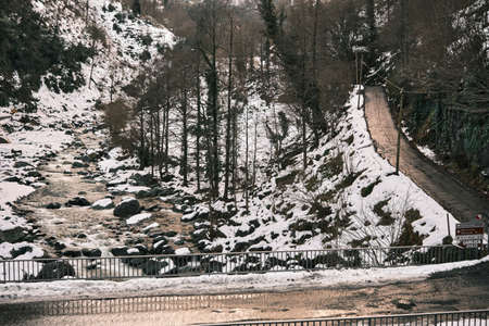 River stream at winter at way of mencuna waterfall way and reflection of road fences at asphalt ground. winter concept idea.の写真素材
