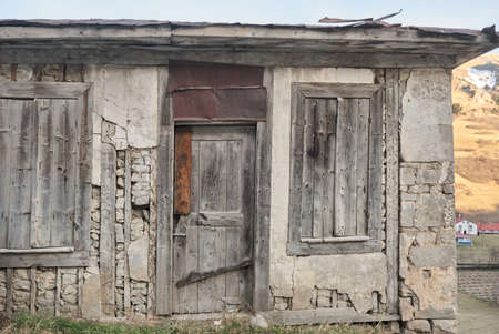 Wooden made house, abandoned and brownfield house and village background.の写真素材