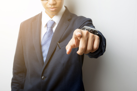 Business man pointing hand and finger for  recruit new job with soft flare and light lineの写真素材