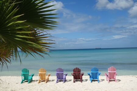 Beach Chairs in Different Colors on Tropical Beachの写真素材