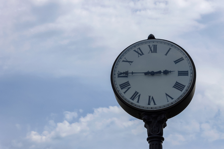 Urban clock on a background of a cloudy skyの写真素材