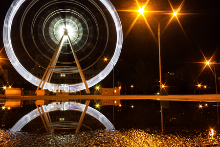 The Ferris wheel in the public park at nightの写真素材