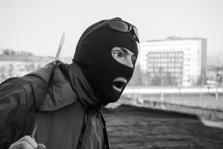 Shock and fear in the eyes of a gangsterの写真素材