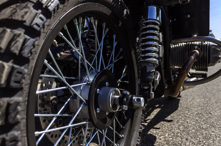 Front wheel of motorcycle with spokes and reinforced spring
