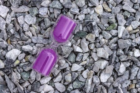 Hourglass lie on small stones