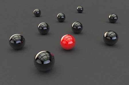 3D image of one glossy red ball, a stranger among many black balls on a gray surfaceの写真素材