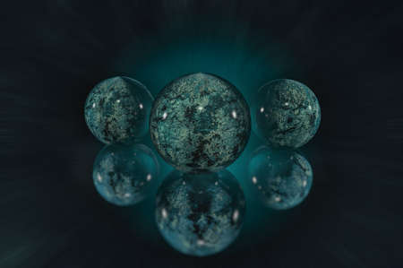 3D textured spheres with a glossy finish on a dark background with a glow and reflection effectの写真素材