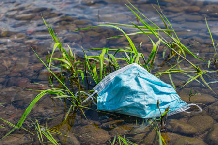 Consequences of the coronavirus pandemic, abandoned medical masks are everywhere. Medical mask...