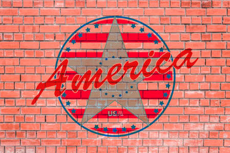Logo in the style of the flag of the USA and the word America depicted on a brick wallの写真素材