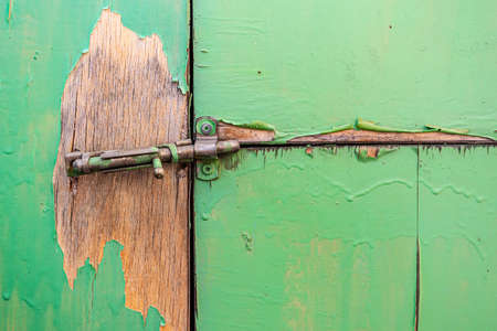 Broken latch close-up not tightly locking ramshackle doors of an old barnの写真素材