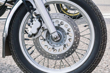 Close-up of the front wheel of a motorcycle and its mechanicsの写真素材