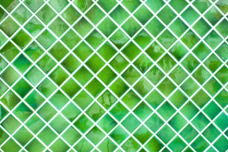 Tiled wall with bunch of green tiles の写真素材