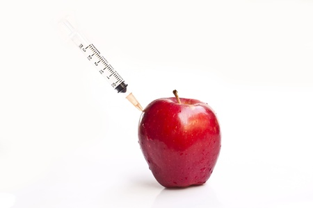 Apple with Needle isolated on white background の写真素材
