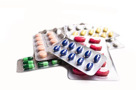 colorful capsules and pills closeup on whiteの写真素材