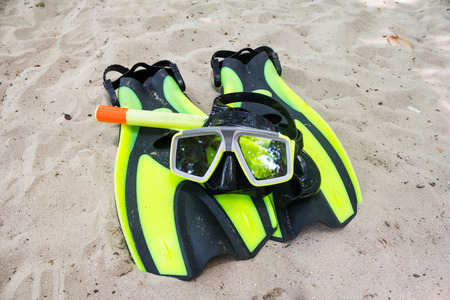 Mask, snorkel and flippers on sandの写真素材