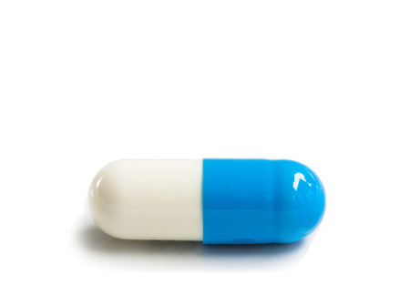 blue and white medical capsules on white blackgroundの写真素材