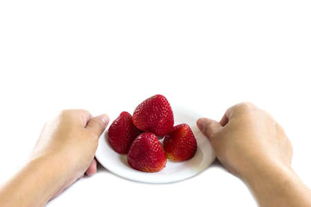 hands holding strawberries isolated on whiteの写真素材