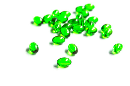 green capsules isolated on white backgroundの写真素材