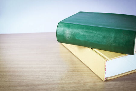 vintage old books stacked on tableの写真素材