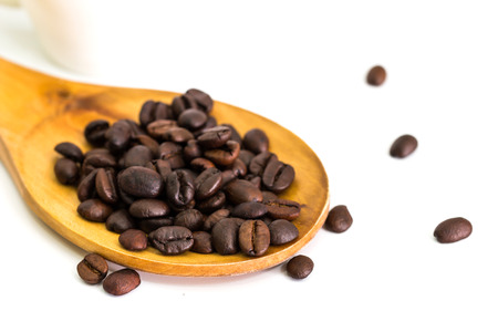 Coffee beans in wooden spoon, close upの写真素材