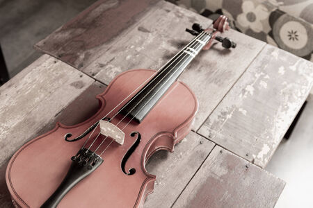 violin in vintage style on wood backgroundの写真素材